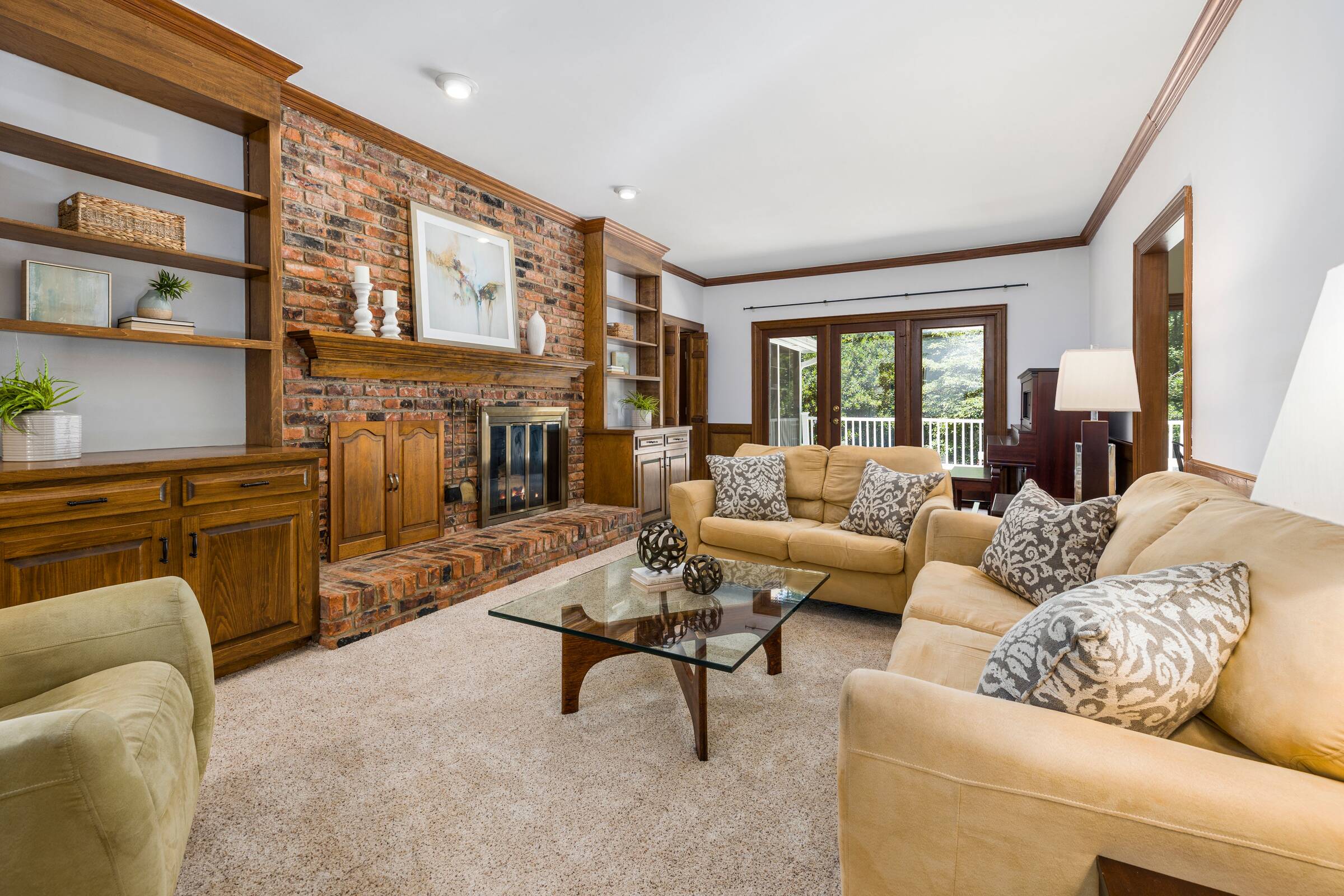 The brick fireplace wall with its built-in shelves